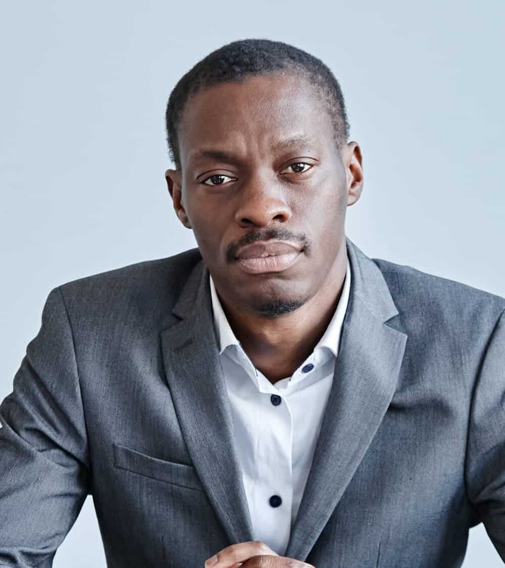 black-businessman-at-workplace-minimal-2023-11-27-05-36-41-utc.jpg
